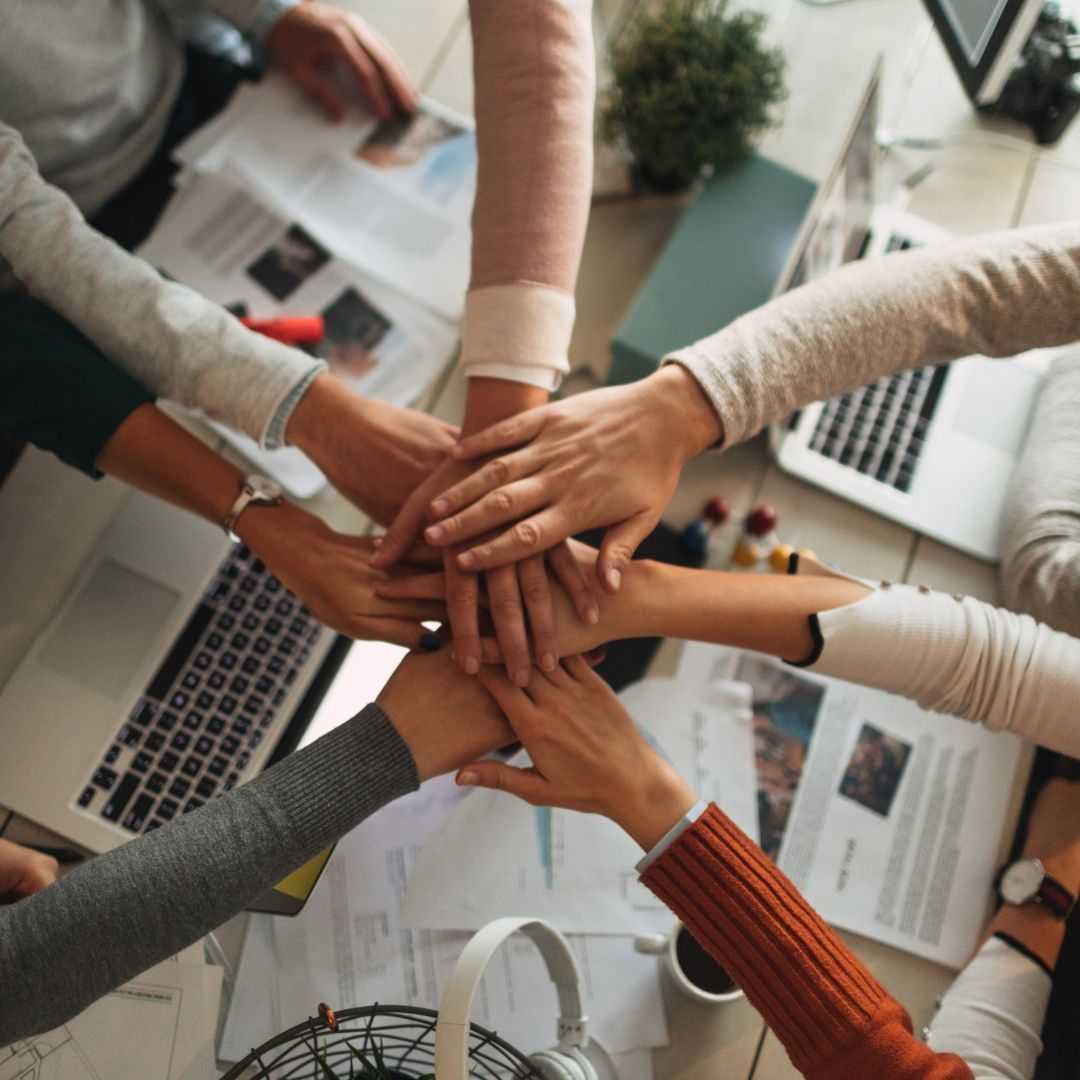 Ali Trading Company team members joining hands together in a spirit of collaboration